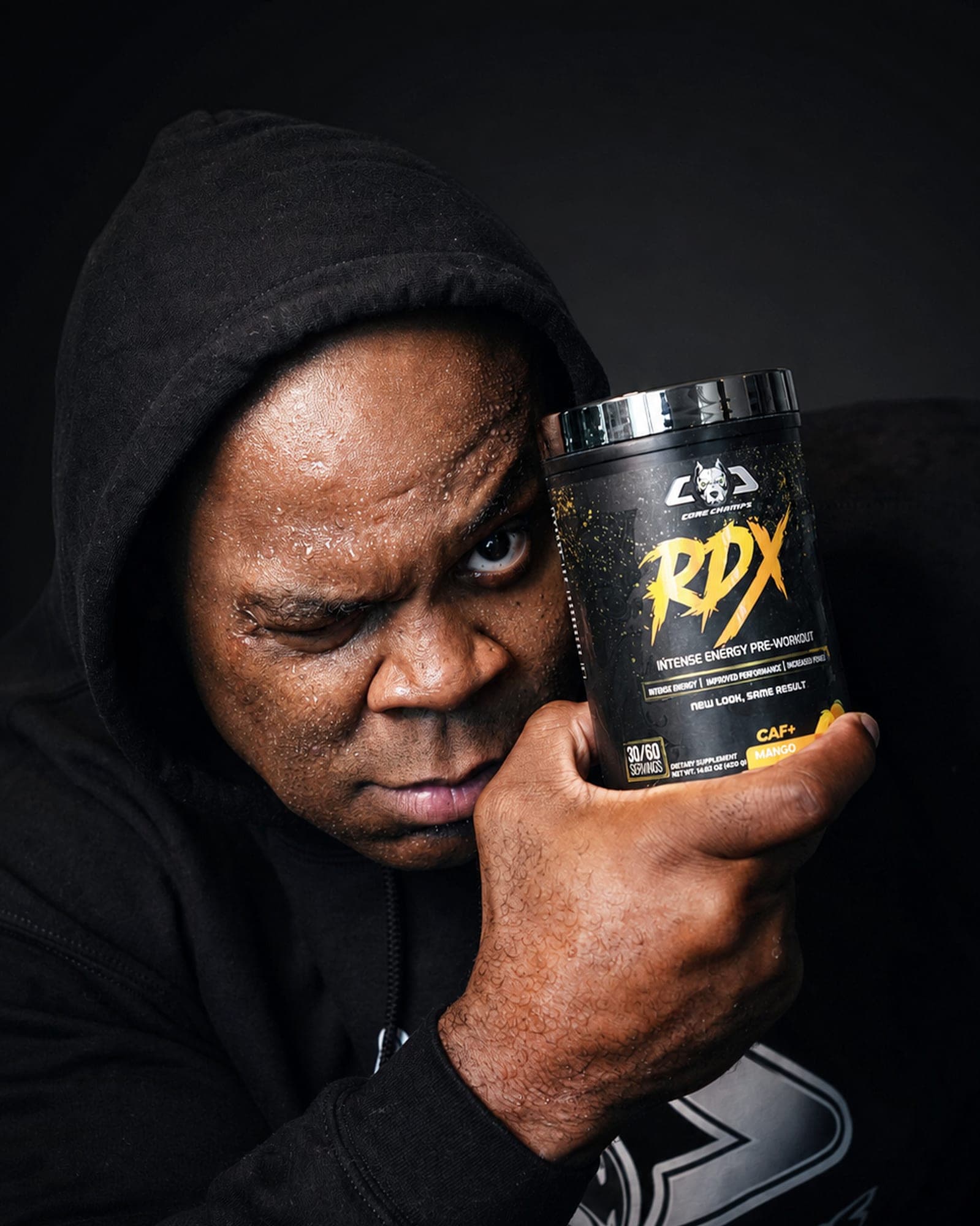 Core Champs athlete holding a tub of RDX intense energy pre-workout